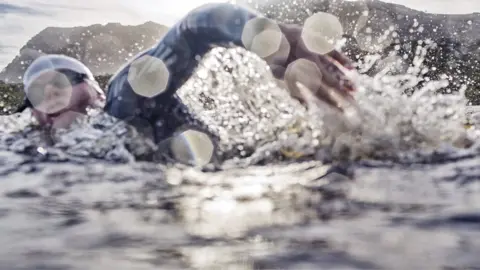 Science Photo Library Man doing open water swim