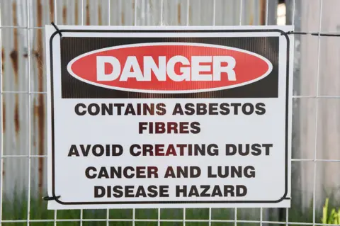 A Periam Photography / Alamy Stock Photo A sign warning of the dangers of asbestos