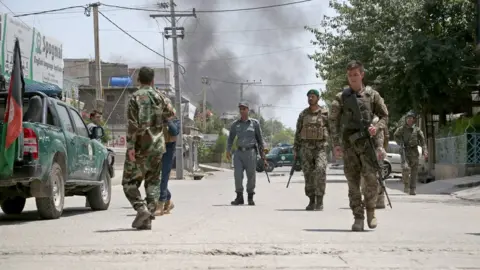 EPA Afghan security officials secure the road outside the scene of the attack