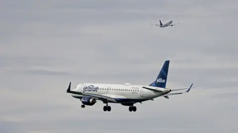 Getty Images A jetBlue airplane heads in for a landing at Boston Logan International Airport