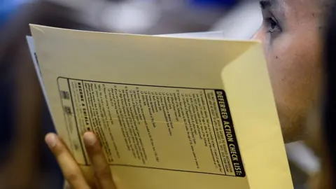 Kevork Djansezian/Getty Images A young person waits to submit their application for the Daca programme in 2012.