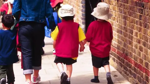 BBC Children and parent walking to school