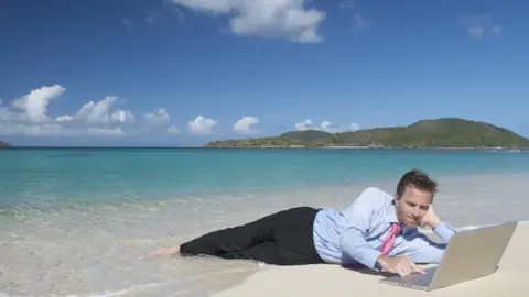 Getty Images Man in suit on beach