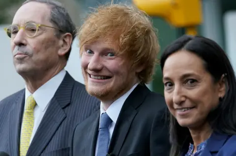 TIMOTHY A CLARY/AFP Ed Sheeran smiles as he leaves Manhattan Federal Court in New York