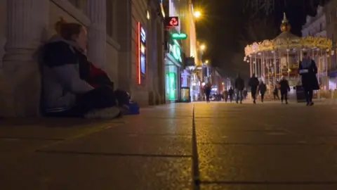 Homeless woman sitting on the street