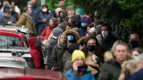 PA Media People queuing for boosters outside a pharmacy in Sevenoaks, Kent