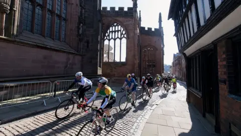 Ian Baker Photography Riders passing Coventry Cathedral