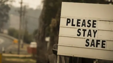 Getty Images Warning sign on the side of the road in NSW reads: Please stay safe