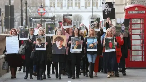  Jonathan Brady/PA Wire Families holding banners