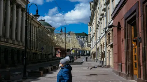 Reuters  A woman walks down a deserted street in central Moscow on April 21, 2020