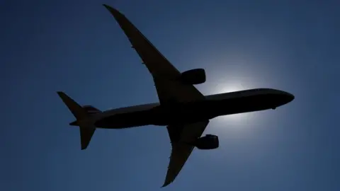 Reuters Aircraft silhouetted in sky over Heathrow