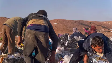 Gabriel Chaim Children rummaging through rubbish from a US military base