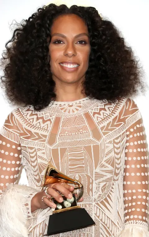 Getty Images Melina Matsoukas holding a Grammy award