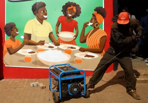 Siphiwe Sibeko/Reuters Man trying to start a generator, 2 August 2023