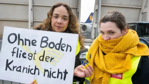 Striking Lufthansa ground crew employees gather at the Lufthansa Aviation Center near the Frankfurt Airport