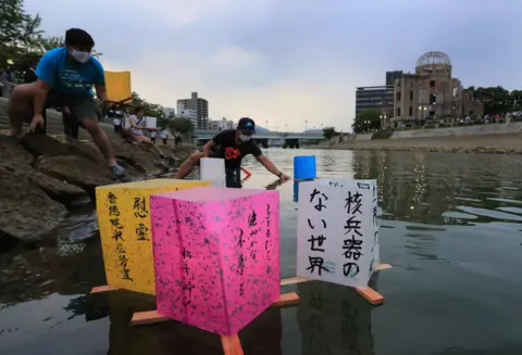 JIJI/EPA People float paper lanterns on water in Hiroshima