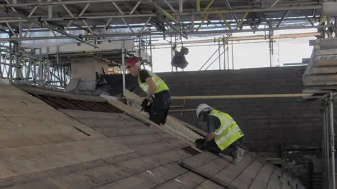 East Suffolk Council Workers on the roof of the old post office, Lowestoft