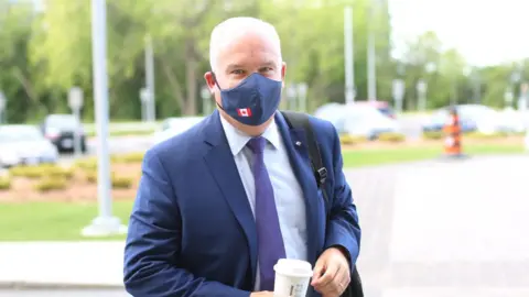 AFP via Getty Images Conservative Party of Canada leader Erin O'Toole arrives on Parliament Hill August 25, 2020