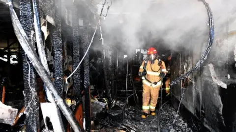 Getty Images A firefighter inspects the gutted hospital in Miryang. Photo: 26 January 2018