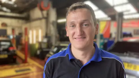 Piers Hopkirk/BBC Close up image of Shane Fry inside his vehicle repair centre on Godstone High Street