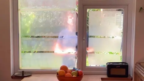 Heatwave Toolkit Yoghurt on a window with a man outside the window