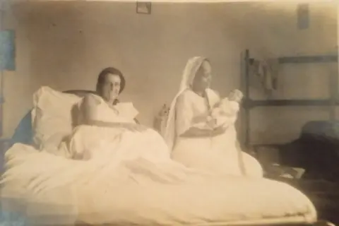 Courtesy of The Royal College of Physicians and Surgeons of Glasgow Jamini Sen along with an unnamed woman and baby