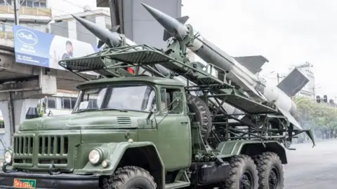 AFP via Getty Images A green military vehicle of the Ethiopian army is seen in Addis Ababa on 26 October 2023