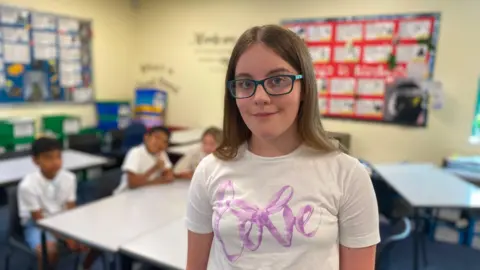 Lizzie stands in the classroom at Manor High School