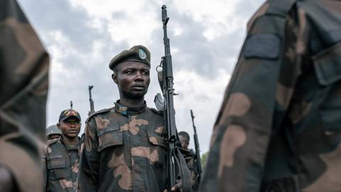 DR Congo army personnel carrying guns outside during training in DR Congo in April