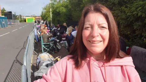 Robby West/BBC Debra Legg at the front of the queue for the Take That concert
