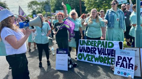 A group of striking healthcare workers on the picket line at Derriford Hospital, Plymouth, in June