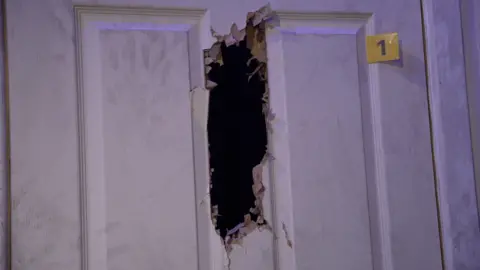 A door with a large hole chopped through the centre