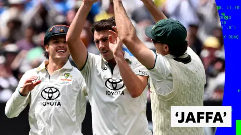 Pat Cummins celebrates taking a wicket