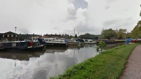 View of a river with boats on it from the path 