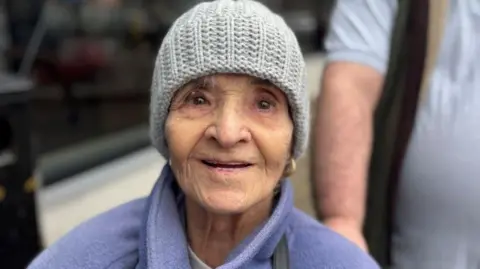 Freda Allen in a fleece with a grey knitted hat.