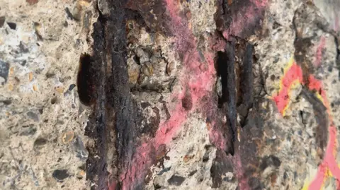 Rusted support rods in the concrete which holds up the A3 in Guildford