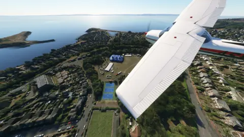 Microsoft A Cessna 152 aircraft performing a flyover of Glastonbarry at Romilly Park, Barry in the video game, Microsoft Flight Simulator.