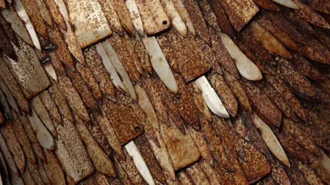REUTERS/Phil Noble The Knife Angel sculpture, also known as The National Monument Against Violence and Aggression, created by artist Alfie Bradley from more than100.000 knives obtained from knife amnesties and weapons seized by British police forces, is on display as part of a national tour in Bolton, Britain, November 6, 2023. 