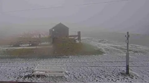 DOI Snow on the ground at the Bungalow on the A18. It is foggy and visibility is poor.