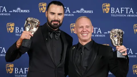 Getty Images Rylan Clark and Robert Rinder pose with the Factual Entertainment Award for 'Rob and Rylan's Grand Tour' inside the Winners Room at the 2025 BAFTA Television Awards with P&O Cruises at The Royal Festival Hall on May 11, 2025 in London, England