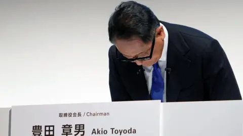 EPA-EFE/REX/Shutterstock Toyota chairman Akio Toyoda bows at the start of a press conference in Tokyo, Japan on 3 June.