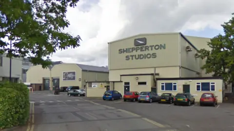 GOOGLE Warehouse-style building with a big sign saying 'Shepperton Studios' 