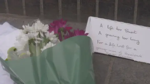 Flowers at murder scene in Saracen Street in Glasgow