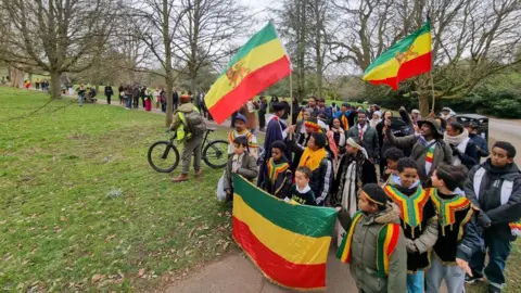 Fairfield Hosue Bath CIC People walking through a park with Ethiopian flags