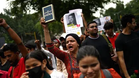 Activists and supporters of the Cockroach Janta Party (CJP) take part in a protest demanding the resignation of India's Education Minister Dharmendra Pradhan over alleged NEET examination irregularities in New Delhi on July 20, 2026