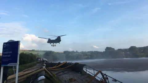 Derbyshire Fire and Rescue Service Helicopter flies over reservoir