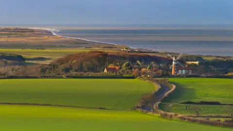 Windmill and North sea Weybourne and north Norfolk coast