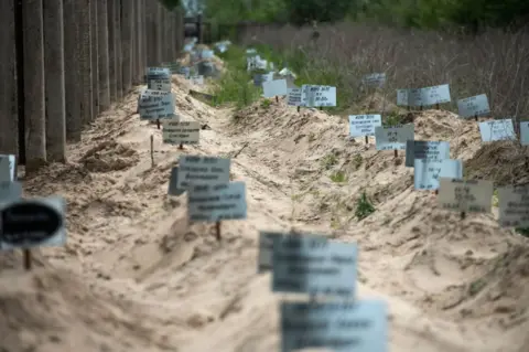 Getty Images Most graves of people who died in the Kyiv region as a result of the full-scale Russian invasion of Ukraine are mostly unmarked near the city of Brovary, Ukraine, on May 17, 2023