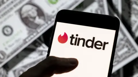 SOPA Images Tinder app on phone