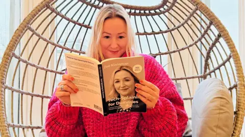 BBC BBC technology editor Zoe Kleinman holding the AI-made book that one of her friends brought her as a present